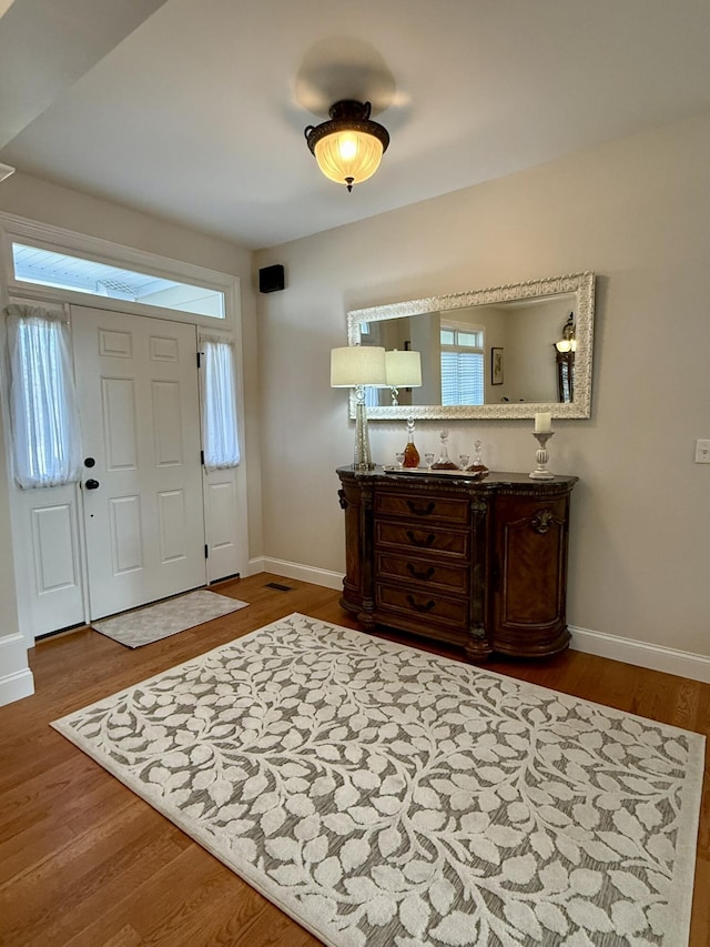 entrance foyer with hardwood / wood-style flooring and a wealth of natural light