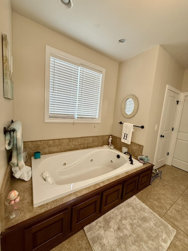 bathroom featuring tile patterned flooring and a tub to relax in