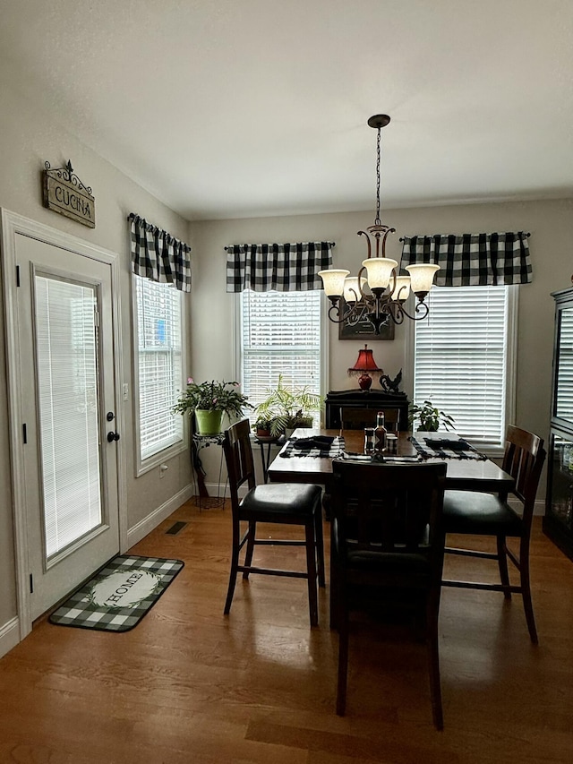 dining space featuring an inviting chandelier and wood-type flooring