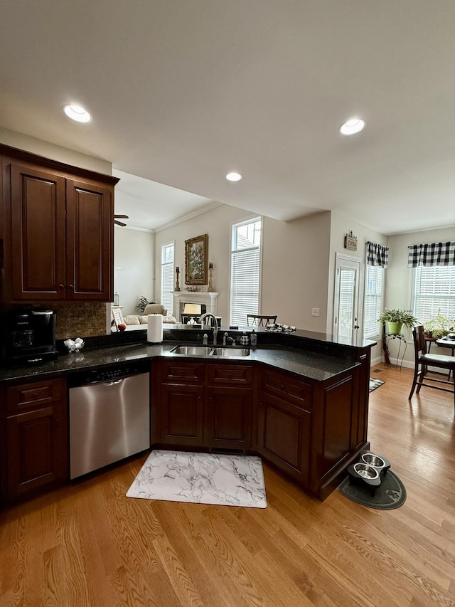 kitchen with sink, stainless steel dishwasher, kitchen peninsula, crown molding, and light hardwood / wood-style flooring