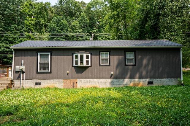 9465 N Hickory Valley Rd, Chattanooga, TN 37416 - view of home's exterior with crawl space, metal roof, and a lawn