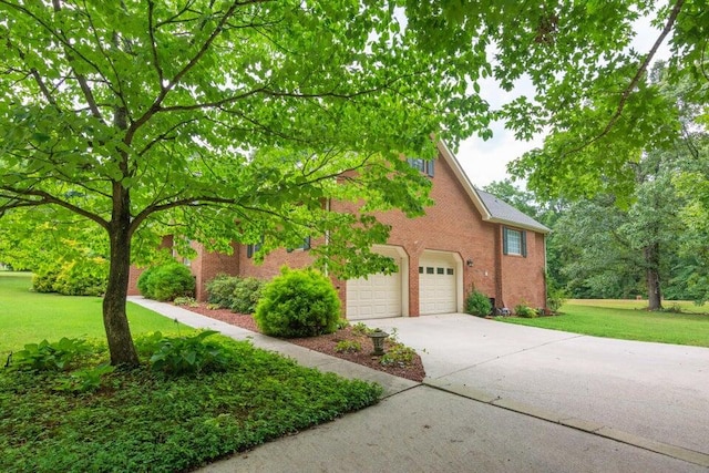 view of front of home with a front lawn and a garage