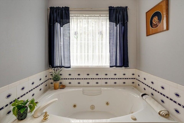 bathroom featuring a bathtub and plenty of natural light