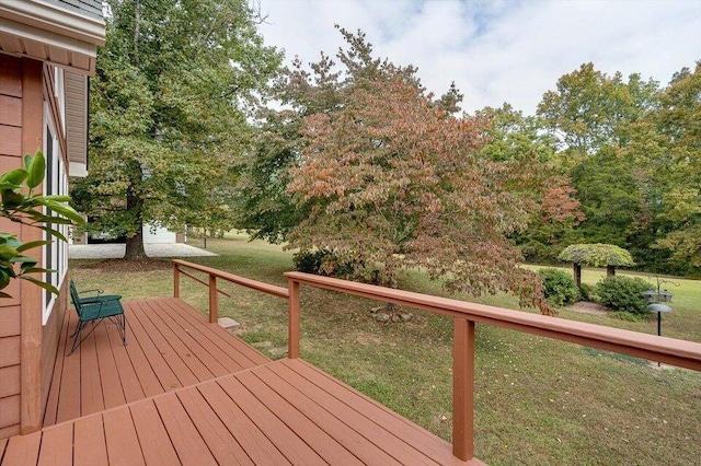 wooden terrace with a yard