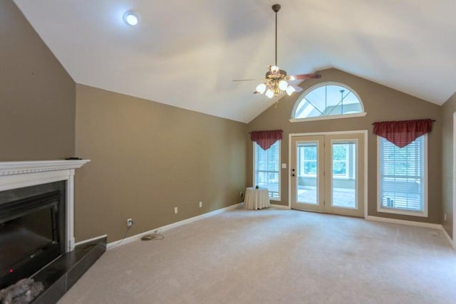 unfurnished living room featuring carpet, ceiling fan, and high vaulted ceiling