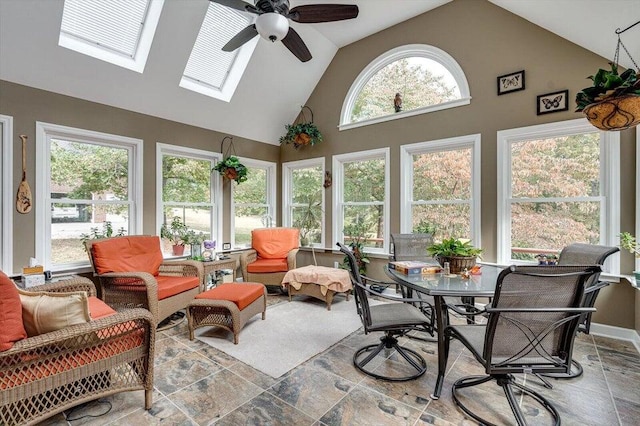 sunroom with a wealth of natural light, vaulted ceiling with skylight, and ceiling fan