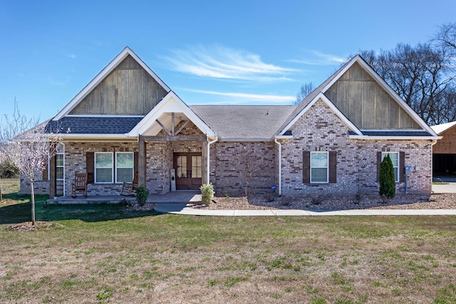 craftsman-style home featuring a front yard and french doors