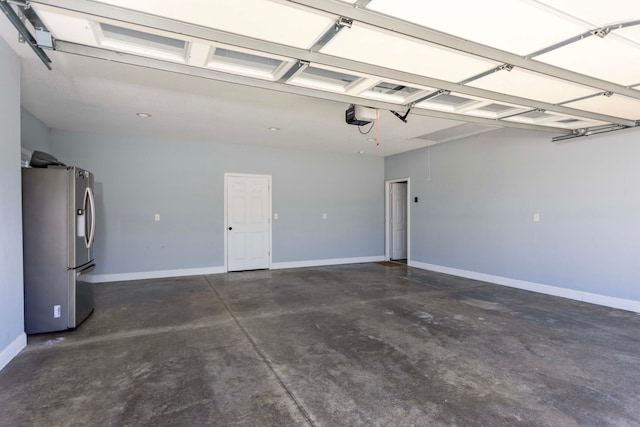 garage featuring stainless steel fridge with ice dispenser and a garage door opener