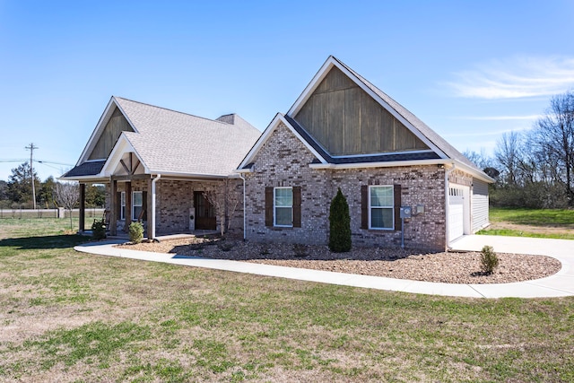 craftsman inspired home with covered porch, a front yard, and a garage