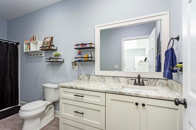 bathroom featuring a shower with shower curtain, wood-type flooring, vanity, and toilet