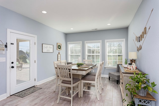 dining space with light hardwood / wood-style floors