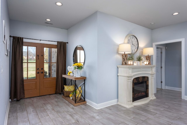 entrance foyer with french doors and light wood-type flooring