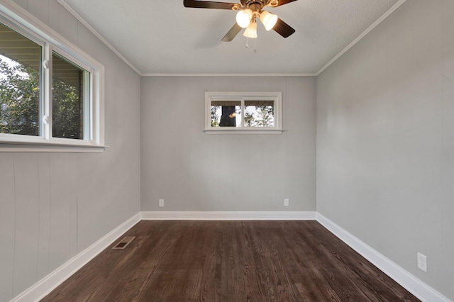 spare room with plenty of natural light, ceiling fan, dark hardwood / wood-style flooring, and ornamental molding