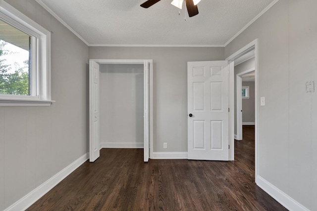 unfurnished bedroom with a textured ceiling, ceiling fan, dark hardwood / wood-style flooring, and crown molding