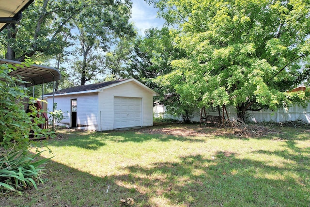 view of yard with a garage and an outdoor structure