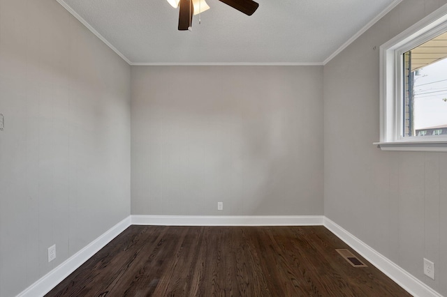 spare room with dark hardwood / wood-style floors, ceiling fan, and ornamental molding