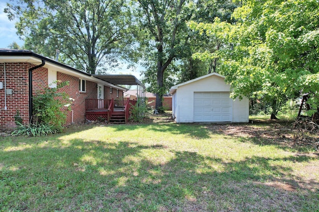 view of yard featuring an outbuilding, a garage, and a wooden deck