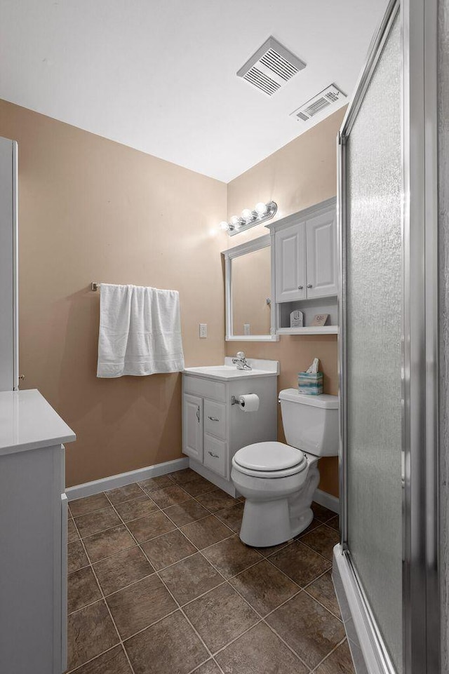 bathroom with a shower stall, visible vents, vanity, and toilet