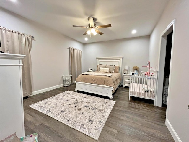 bedroom with recessed lighting, dark wood-type flooring, and baseboards