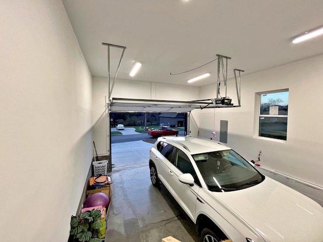 garage with electric panel and a garage door opener
