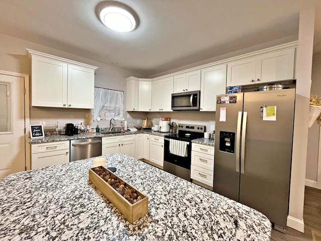 kitchen with white cabinetry, appliances with stainless steel finishes, and a sink