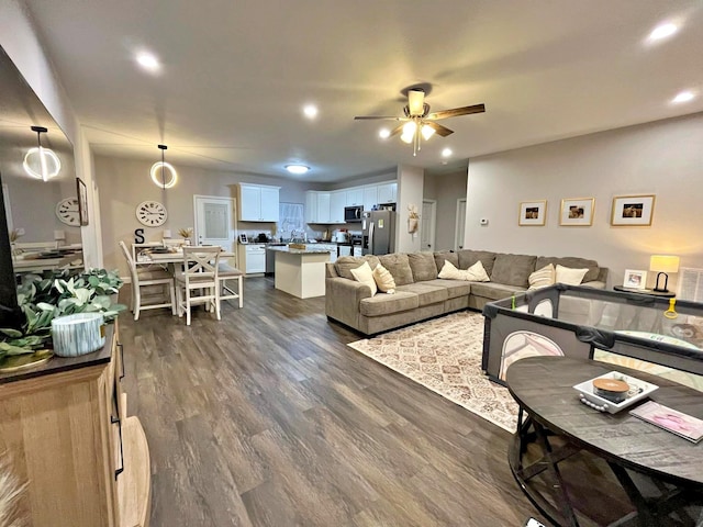 living area with recessed lighting, ceiling fan, and dark wood-style flooring