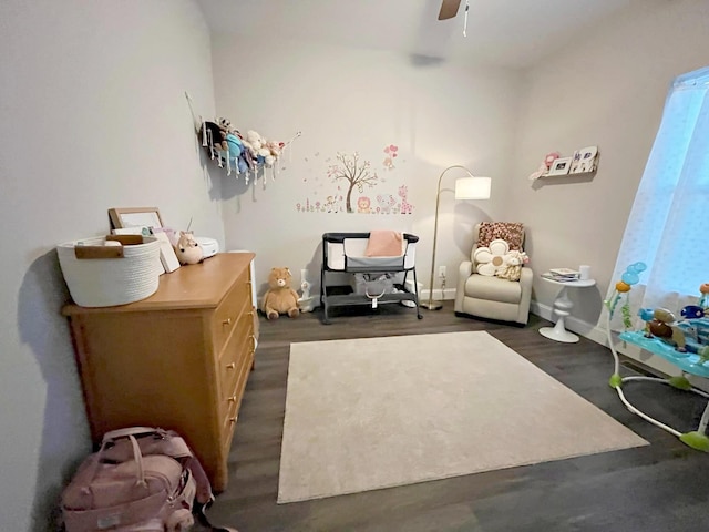 bedroom featuring baseboards, dark wood-type flooring, and a ceiling fan