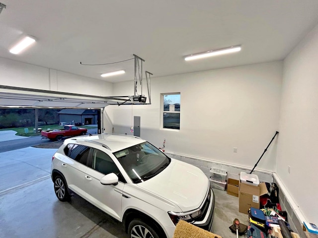 garage with electric panel and a garage door opener