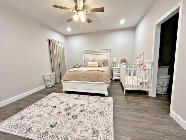 bedroom with recessed lighting, baseboards, and dark wood-type flooring