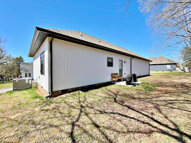 back of house featuring crawl space and a lawn