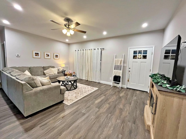living area with recessed lighting, baseboards, ceiling fan, and dark wood-style flooring
