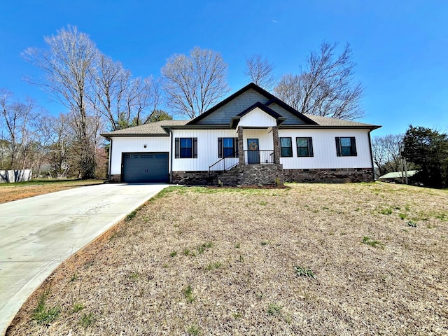 view of front of home featuring a front yard, a garage, driveway, and crawl space