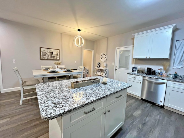 kitchen featuring stainless steel dishwasher, light stone counters, dark wood finished floors, and white cabinetry