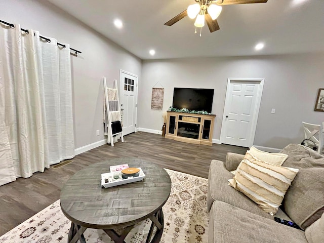 living room featuring recessed lighting, baseboards, ceiling fan, and wood finished floors