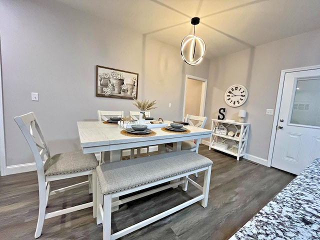 dining room featuring dark wood-style floors and baseboards