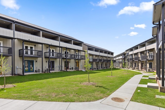 view of home's community featuring a lawn and a residential view