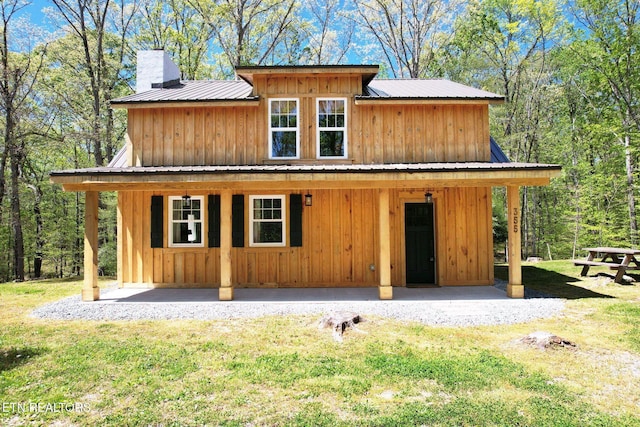 355 Cross Keys Ln, Ten Mile, TN 37880 - view of front of property with metal roof, a chimney, a front lawn, and board and batten siding