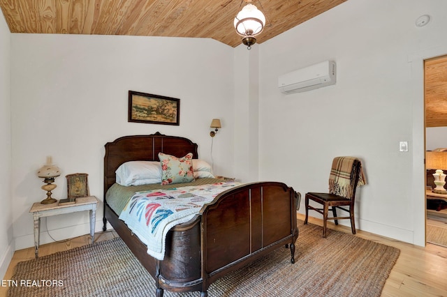 355 Cross Keys Ln, Ten Mile, TN 37880 - bedroom featuring an AC wall unit, wooden ceiling, baseboards, and wood finished floors