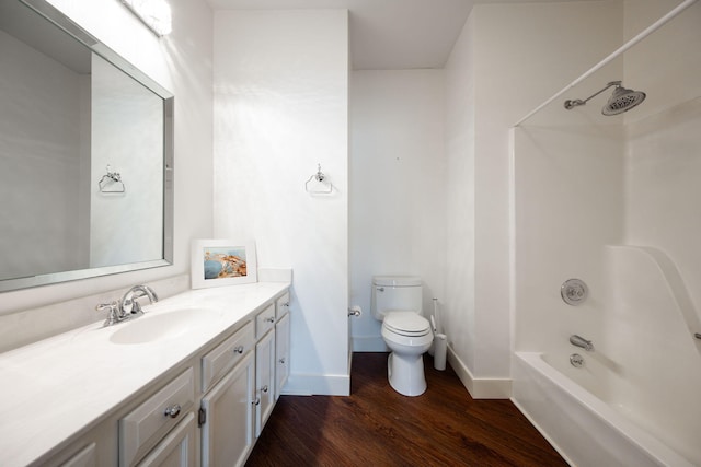 full bathroom featuring toilet, wood-type flooring, vanity, and bathtub / shower combination