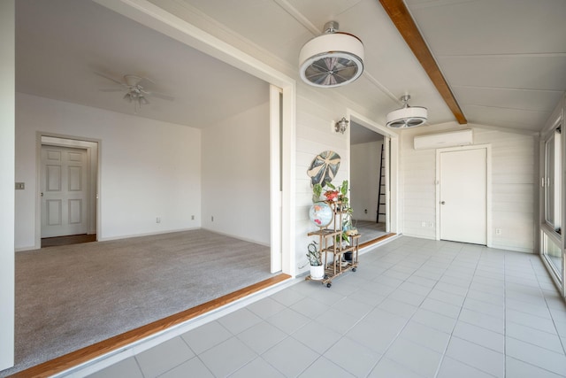 carpeted foyer with ceiling fan, a wall mounted air conditioner, and vaulted ceiling with beams