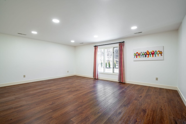 unfurnished room with dark hardwood / wood-style floors