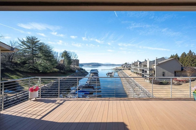 dock area with a balcony and a water view