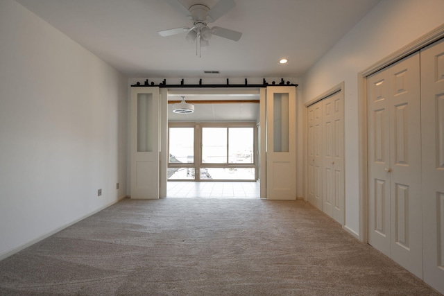 hallway featuring light colored carpet