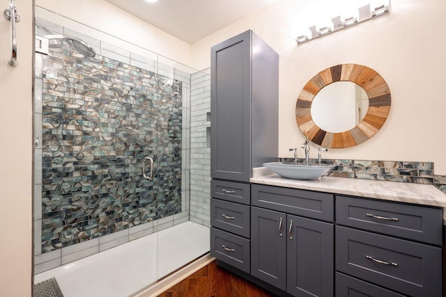 bathroom featuring vanity and a shower with door