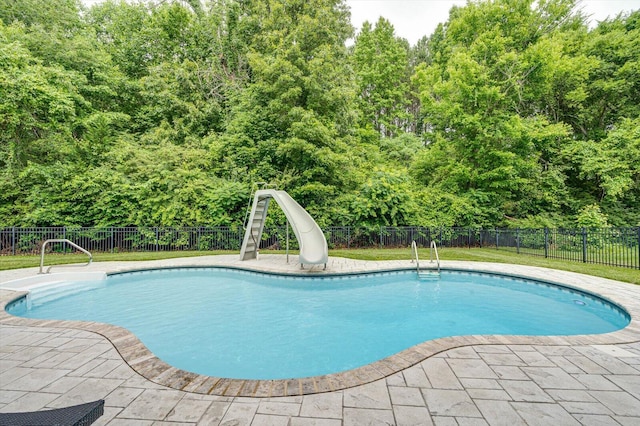 view of pool with a water slide, sink, and a patio