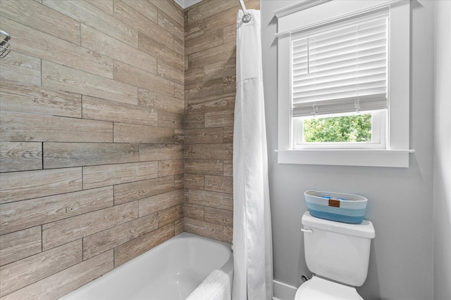 bathroom with shower / bath combination with curtain and toilet