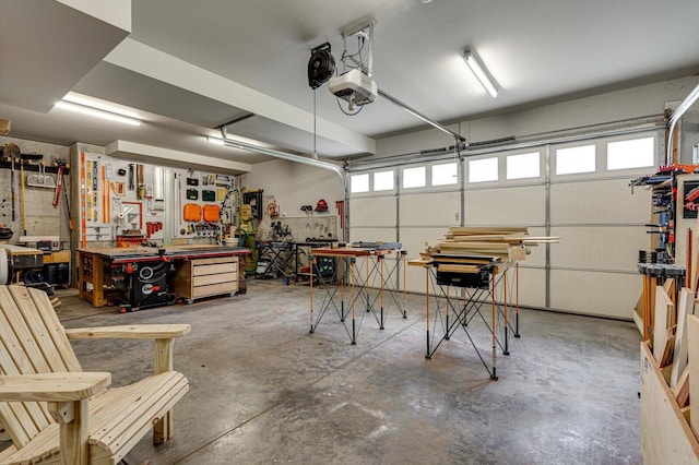 garage featuring a garage door opener and a workshop area