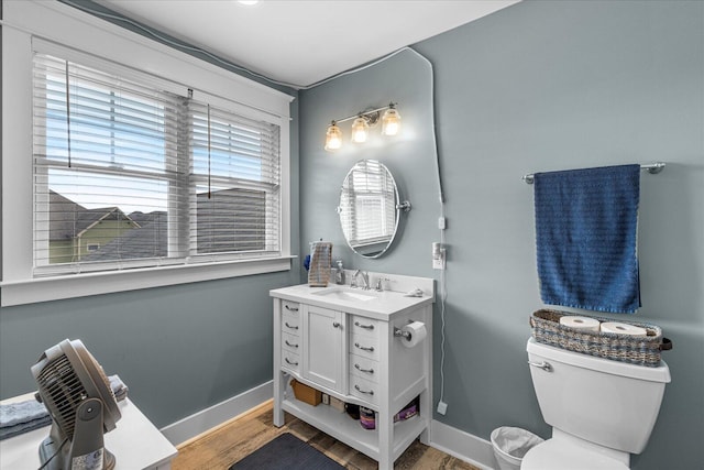 bathroom featuring vanity, hardwood / wood-style flooring, and toilet