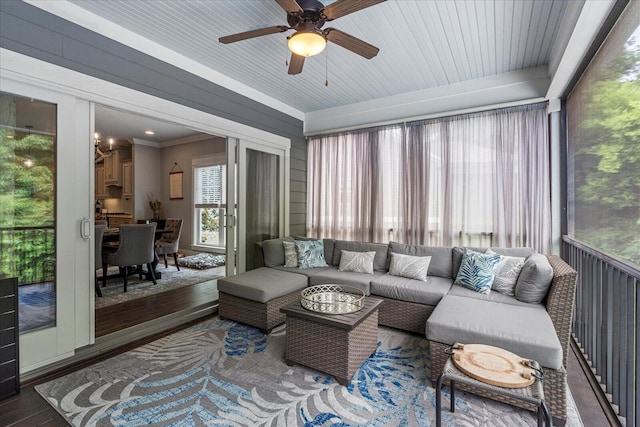 sunroom / solarium featuring ceiling fan