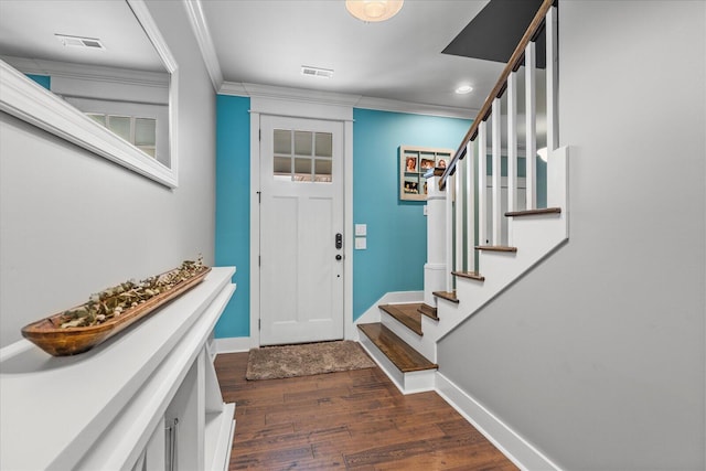 entrance foyer featuring dark wood-type flooring and ornamental molding